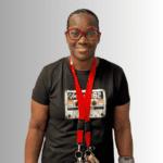 Woman wearing a vintage t-shirt and glasses.