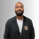 Smiling man in a black jacket.