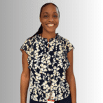 Smiling woman in floral top and lanyard.