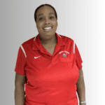 Smiling woman in red Miami Edison shirt.