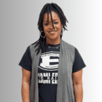 Smiling woman in Miami Edison shirt.