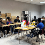 Students engaged in activities in a classroom.