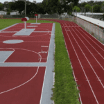 Basketball court and running track outdoors.