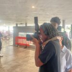 Photographer capturing a subject in a park.